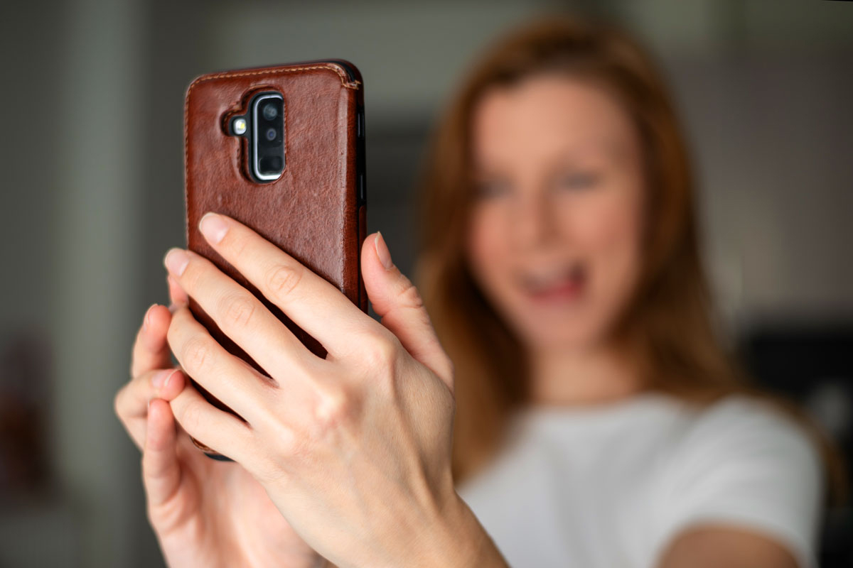 Woman shooting vertical video with her phone