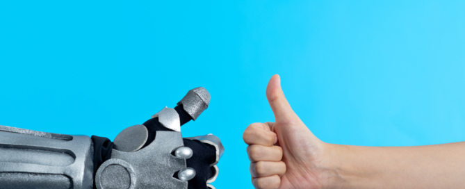 Two hands (one robot and one human) give thumbs up